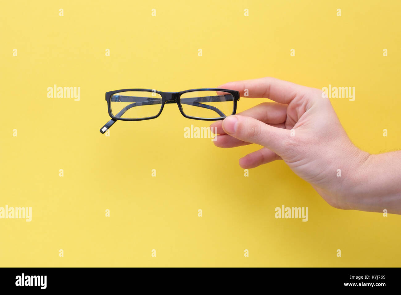 Eyesight concept.Hand holding glasses Stock Photo
