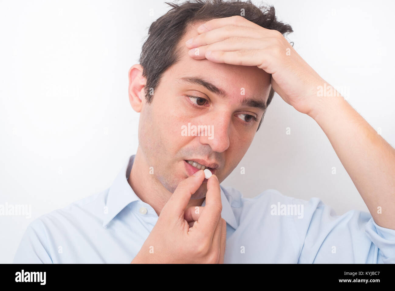 Sick man eating aspirin pill medication Stock Photo Alamy