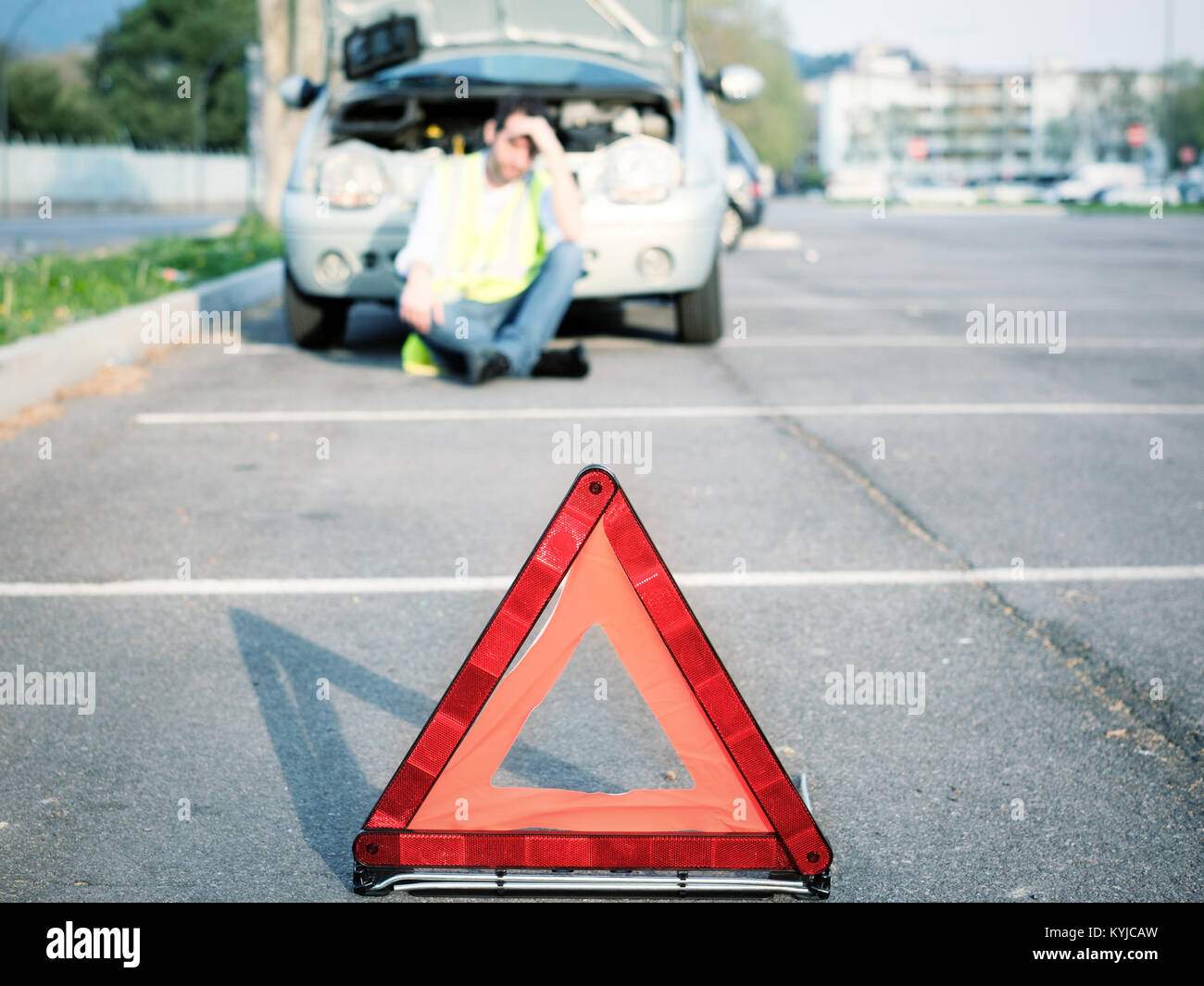 Sad man calling and waiting for mechanic service after vehicle breakdown Stock Photo