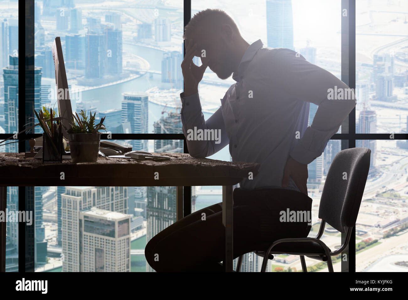 Young Businessman Suffering From Backpain In Modern Office Stock Photo ...