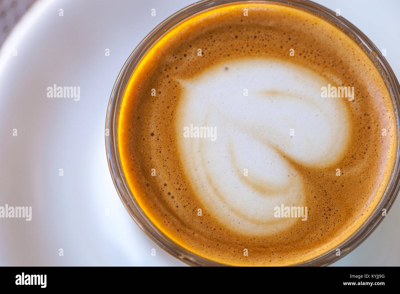 Top view of cortado coffee in a glass with the foam in shape of heart Stock Photo