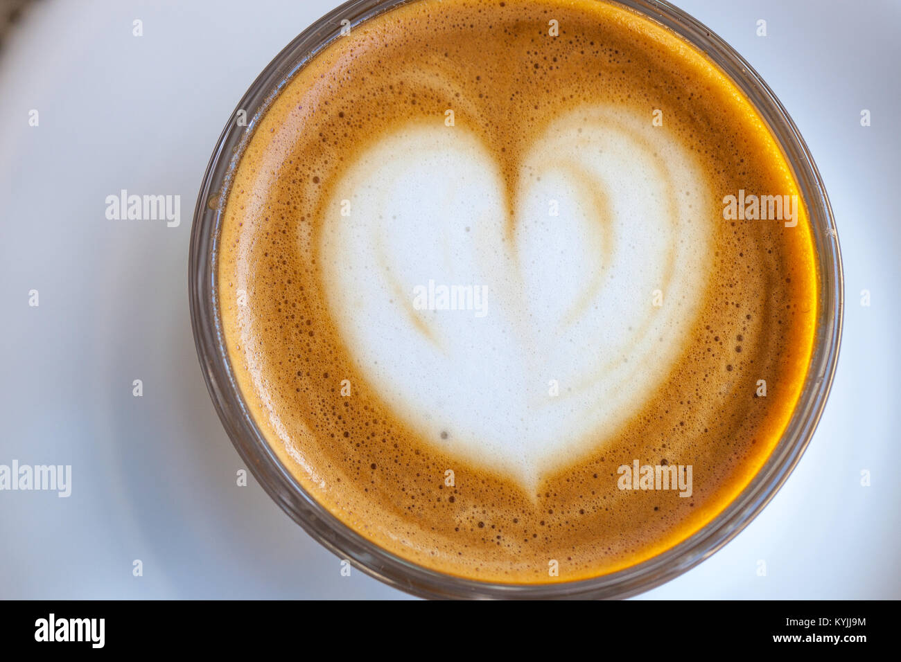 Top view of cortado coffee in a glass with the foam in shape of heart Stock Photo
