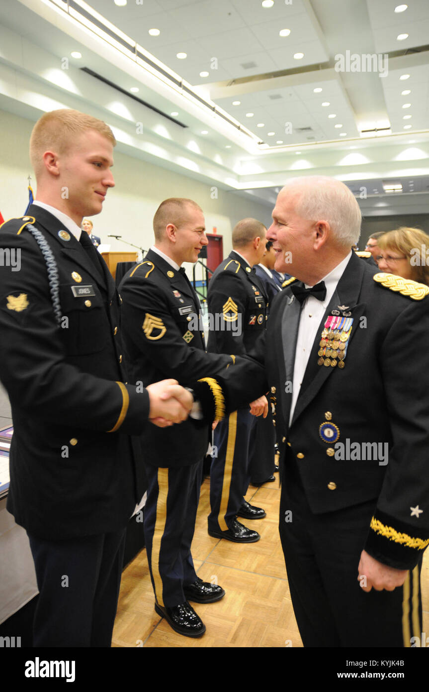 Brig. Gen. Benjamin F. Adams, chief of the Joint Staff, Joint Forces Headquarters, Kentucky National Guard, congratulates the Kentucky Army National Guard Soldier of the Year, Spc. Christopher Jones at the conclusion of the 2015 Outstanding Airman and Soldier of the Year Banquet March 14, 2015 at the Kentucky Fair and Exposition Center in Louisville, Kentucky. The annual awards dinner honors Kentucky's finest Airmen and Soldiers who are recognized by their peers for dedicating themselves to the welfare and security of our nation. (Photo by Sgt. 1st Class Gina Vaile-Nelson, 133 MPAD/KYARNG RELE Stock Photo