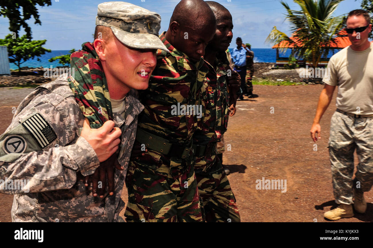 U.S. Army 2nd Lt. Justin Gilliam, Medical Section, 2nd Battalion, 138th Field Artillery, teaches members of the Comoros military various buddy carries in Moroni, Comoros, Jan. 23, 2013. Gilliam is deployed in support of Combined Joint Task Force-Horn of Africa, which conducts military operations, activities and exercises to promote partnership, security and prosperity in East Africa. (U.S. Air Force photo by Airman 1st Class Nicholas Byers/Released) Stock Photo