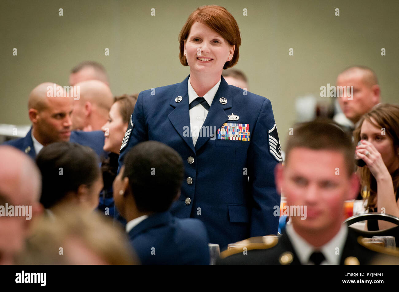 Master Sgt. Sharon Foster, the Senior Non-Commissioned Officer in Charge of Force Support for the 123rd Force Support Squadron stands at attention during the Outstanding Airman and Soldier of the Year Banquet in Louisville, Ky., on March 16, 2013. Foster is the Kentucky Air National Guard’s Outstanding Senior Non-Commissioned Officer of the Year for 2013. (U.S. Air Force photo by Staff Sgt. Maxwell Rechel) Stock Photo