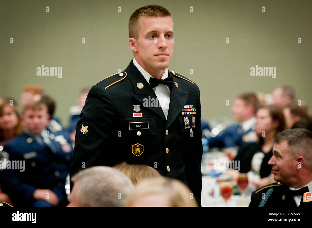 Specialist Nicholas Ray, a combat medic with the 617th Military Police Company, stands at attention during the Outstanding Airman and Soldier of the Year Banquet in Louisville, Ky., on March 16, 2013. Ray is the Kentucky Army National Guard’s Outstanding Soldier of the Year for 2013. (U.S. Air Force photo by Staff Sgt. Maxwell Rechel) Stock Photo