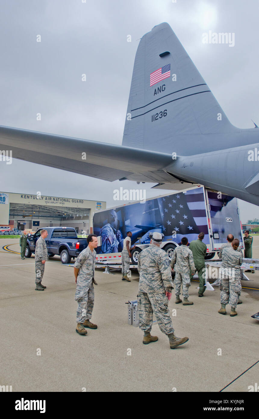 Airmen from the Kentucky Air National Guard load a prototype mobile field kitchen onto 123rd Airlift Wing C-130 Hercules aircraft at the Kentucky Air Guard Base in Louisville, Ky., during field testing of the trailer June 27, 2013. The Disaster Relief Mobile Kitchen Trailer can be deployed to the site of a natural disaster to provide hot meals for relief workers. (U.S. Air National Guard photo by Master Sgt. Phil Speck) Stock Photo