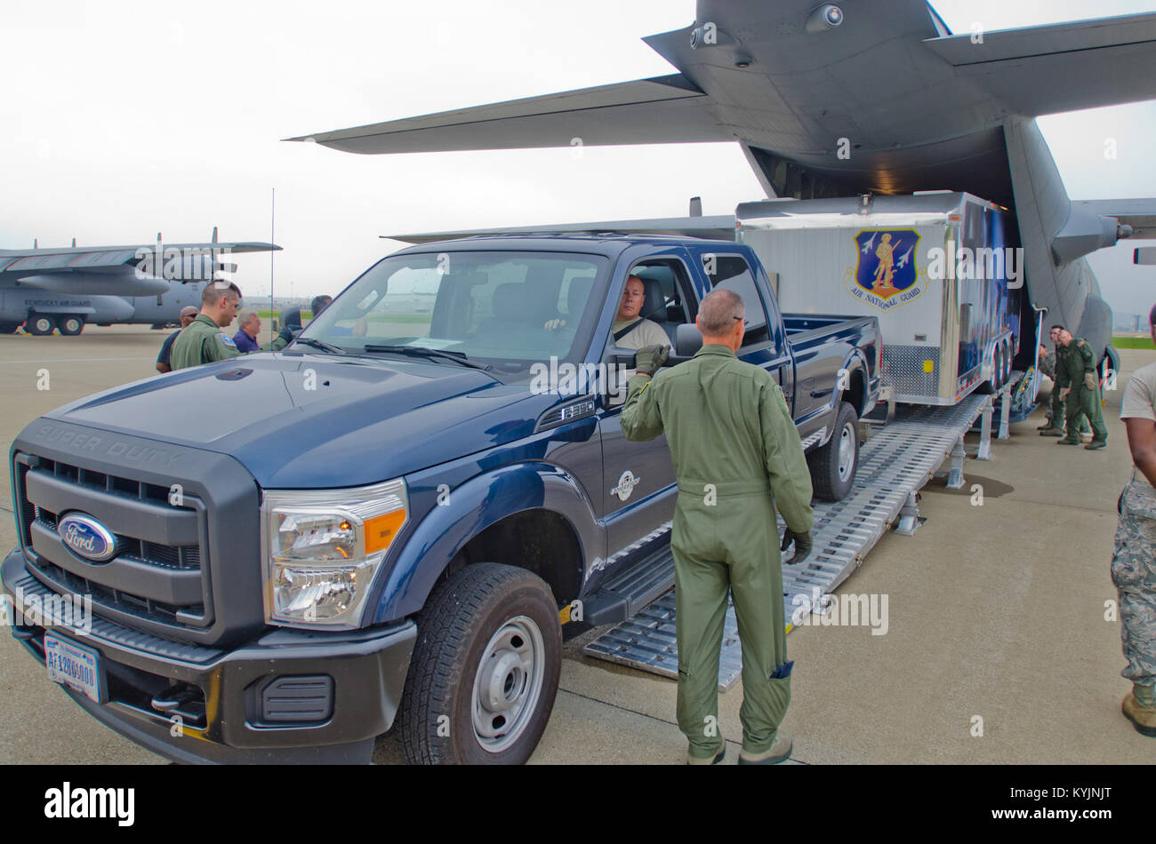 Airmen from the Kentucky Air National Guard load a prototype mobile field kitchen onto 123rd Airlift Wing C-130 Hercules aircraft at the Kentucky Air Guard Base in Louisville, Ky., during field testing of the trailer June 27, 2013. The Disaster Relief Mobile Kitchen Trailer can be deployed to the site of a natural disaster to provide hot meals for relief workers. (U.S. Air National Guard photo by Master Sgt. Phil Speck) Stock Photo