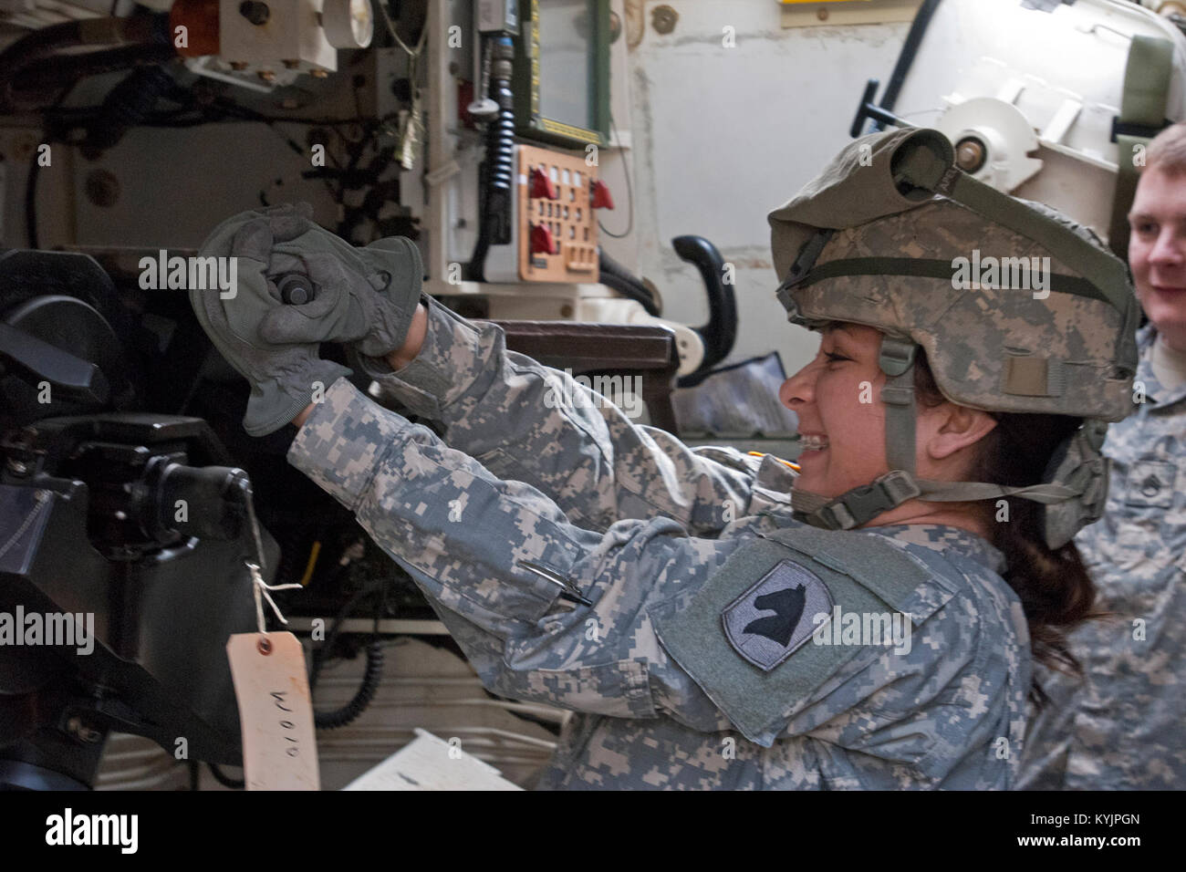 Sgt. Alexa Becerra with the 138th Field Artillery opens the breech of a  M109 Paladin during an exercise at Fort Knox, Ky., March 8, 2014. (U.S. Army  National Guard photo by Staff