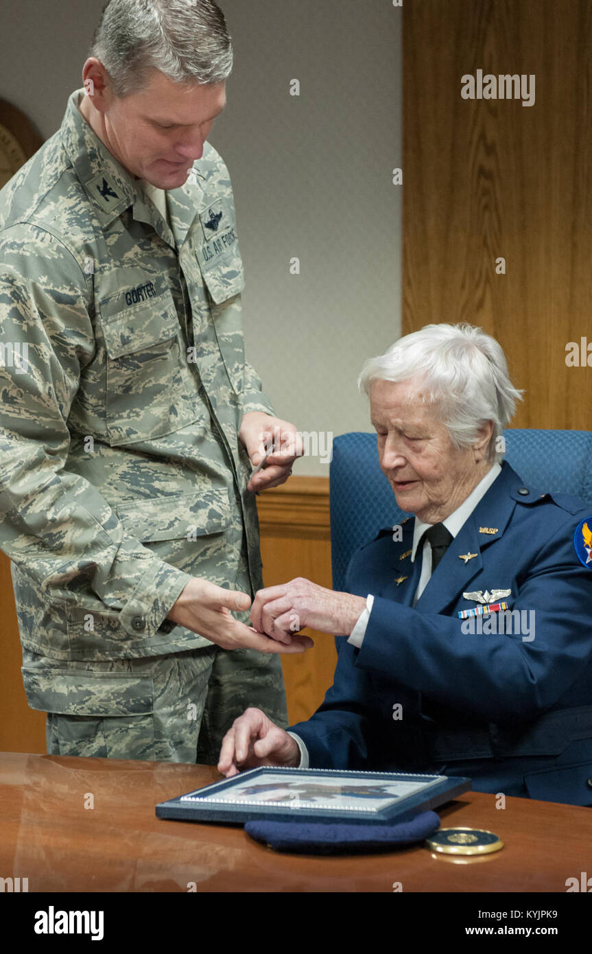 Col. Barry Gorter, commander of the 123rd Airlift Wing, presents Florence Shutsy Reynolds, 91, a former member of the Women Airforce Service Pilots corps during World War II, with a wing coin and certificate identifying her as an Honorary Wing Commander during her visit to the Kentucky Air National Guard Base in Louisville, Ky., March 22, 2014. The WASP program’s primary focus was to reassign responsibility for flight operations over the United States from male to female pilots, freeing men to go to war. (U.S. Air National Guard photo by Staff Sgt. Vicky Spesard) Stock Photo