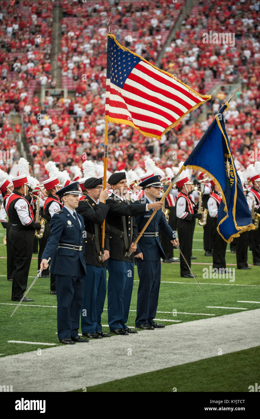 The University of Louisville honors servicemembers during the U of L-Murray State football game at Papa John's Cardinal Stadium in Louisville, Ky., Sept. 6, 2014. The game, billed as Military Appreciation Day, started with a coin toss executed by Air Force Brig. Gen. Warren Hurst, the Kentucky National Guard's assistant adjutant general for Air and commander of the Kentucky Air National Guard. Recruiters from the Kentucky Army and Air Guard also set up booths featuring displays of military equipment and answered questions posed by hundreds of fans. (U.S. Air National Guard photo by Maj. Dale G Stock Photo