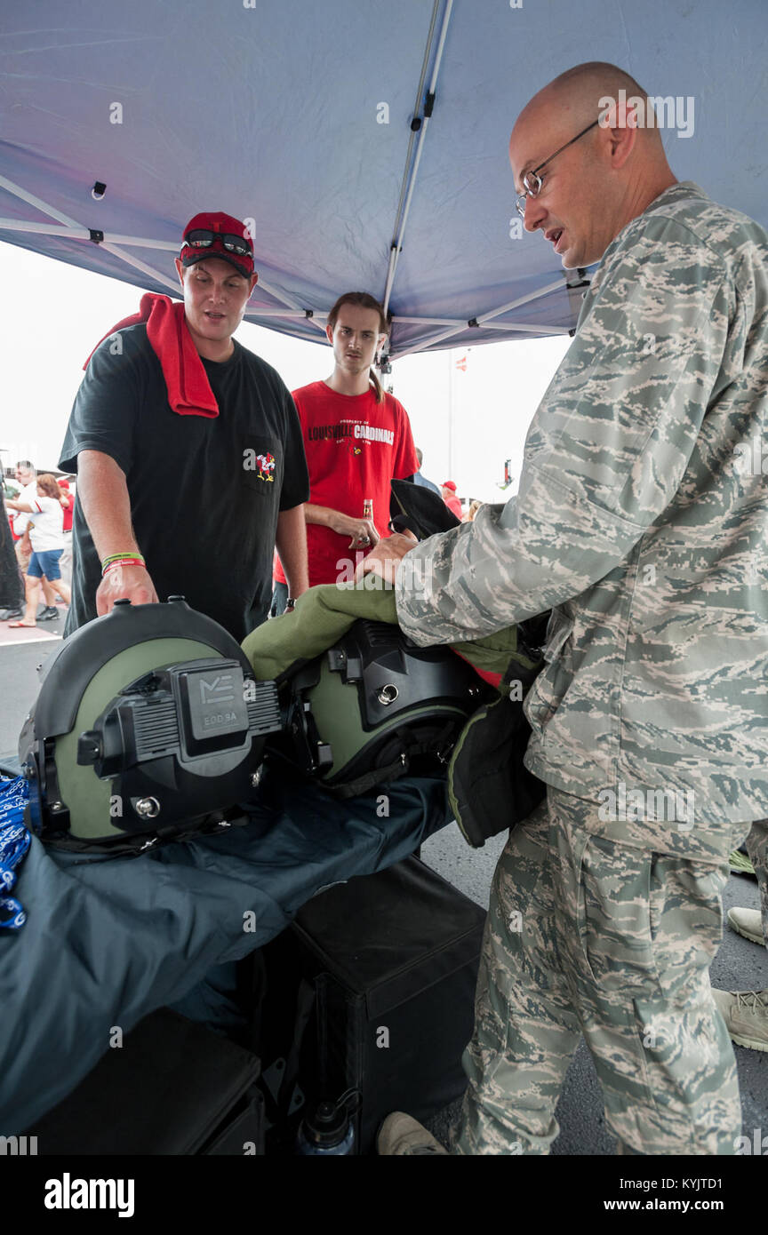 Air Force Maj. Keith Smith, commander of the Kentucky Air National Guard’s 123rd Explosive Ordnance Disposal Flight, displays EOD protective equipment to a football fan outside Papa John’s Cardinal Stadium in Louisville, Ky., prior to the University of Louisville – Murray State football game Sept. 6, 2014. The game, billed as Military Appreciation Day, began with a coin toss executed by Air Force Brig. Gen. Warren Hurst, the Kentucky National Guard's assistant adjutant general for Air and commander of the Kentucky Air National Guard. (U.S. Air National Guard photo by Maj. Dale Greer/Released) Stock Photo