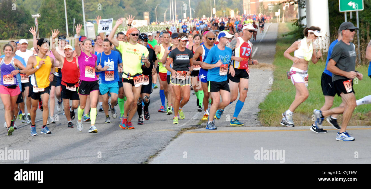 A group of runners turn a corner at mile 6 of the Air Force marathon on