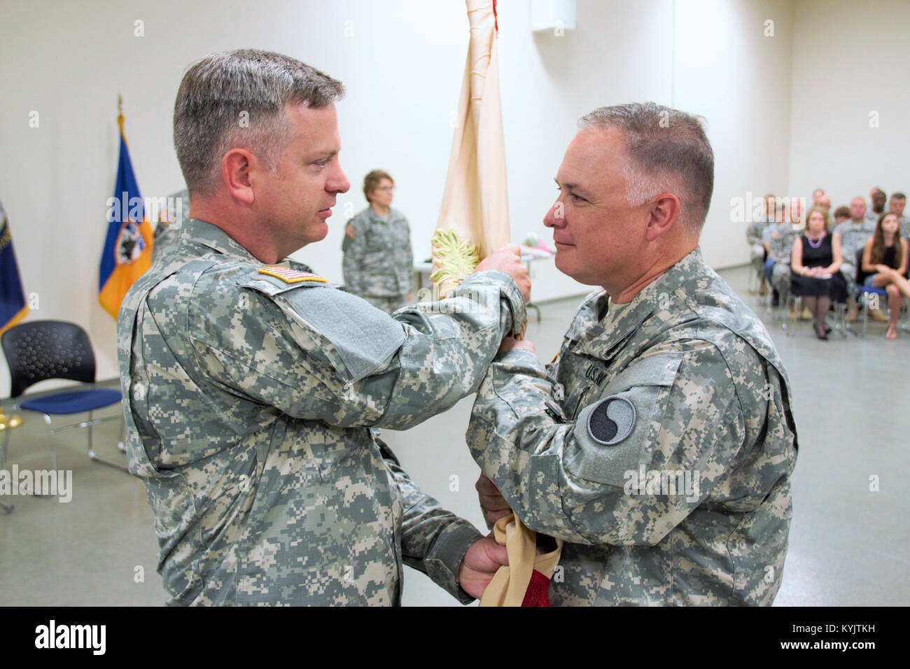 Lt Col. (P) Michael Stephens (left), Commander of the 63rd Theater Aviation Brigade passes the guidon to Lt. Col. Mark A. Brozak. Lt. Col. Brozak is the new  commander of the 1204th  Aviation Support Battalion in Burlington, Ky. Sep. 28, 2014. (U.S. Army National Guard photo by 2nd Lt. Michael Reinersman) Stock Photo