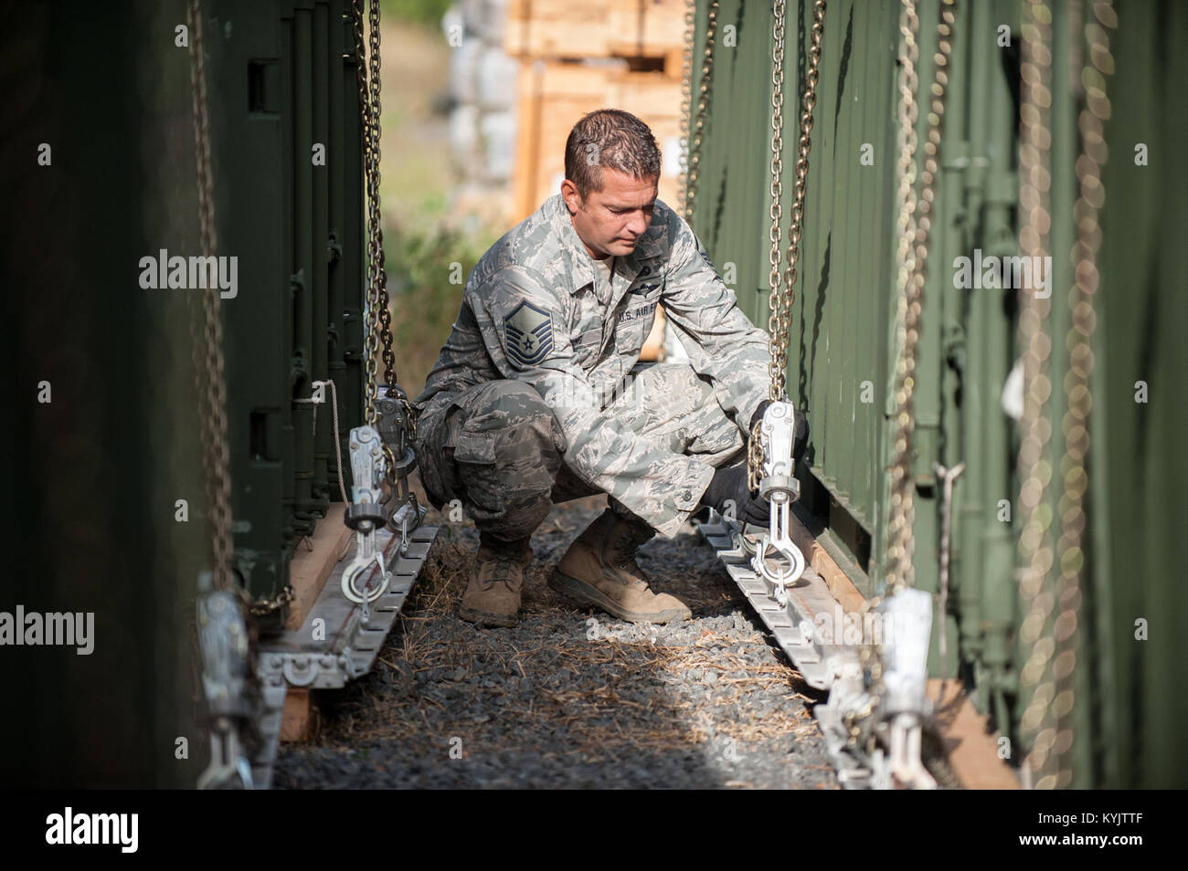 U.S. Air Force Master Sgt. Charles Wilding, an aerial porter from the Kentucky Air National Guard’s 123rd Contingency Response Group, tightens the chains on a pallet of cargo outside the Joint Operations Center at Léopold Sédar Senghor International Airport in Dakar, Senegal, Oct. 24, 2014. Wilding and more than 70 other Kentucky Air Guardsmen are operating an Aerial Port of Debarkation in Senegal to funnel humanitarian supplies and military support into West Africa as part of Operation United Assistance, the U.S. Agency for International Development-led, whole-of-government effort to contain  Stock Photo