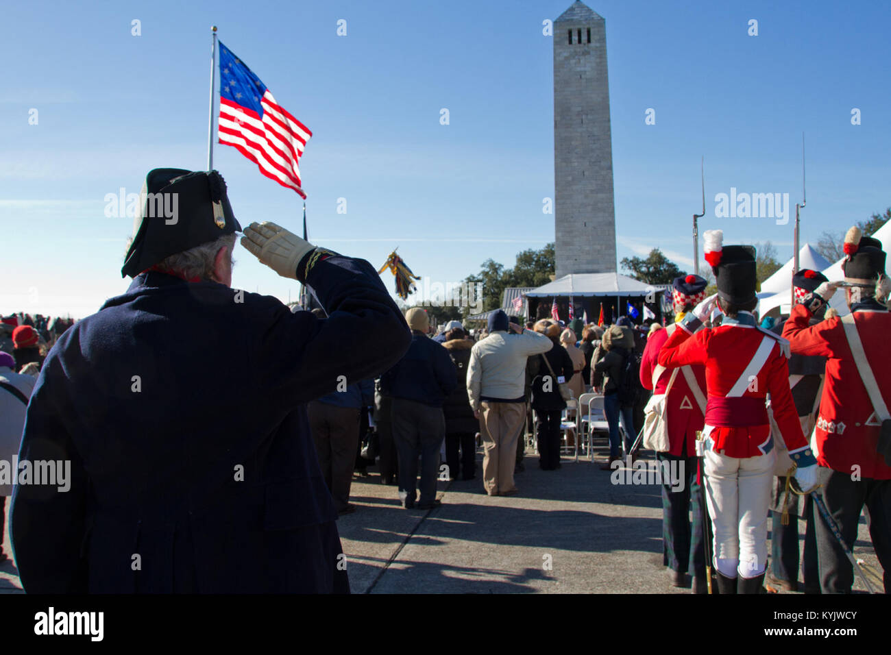 Spectators and reenactors salute during the National Anthem during the ...