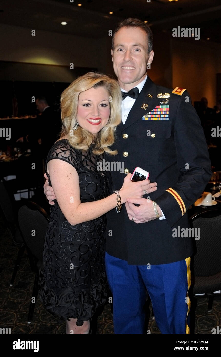 Maj. John Harvey, executive officer of the 149th Brigade Support Battalion, and his wife Miranda enjoy a laugh at the 2015 Sweethearts Ball at the Sloan Convention Center in Bowling Green, Ky., February 14. Harvey enjoyed being able to spend Valentine's Day with his wife. (Photo by Sgt. Brandy Mort, 133rd Mobile Public Affairs Detachment, Kentucky Army National Guard) Stock Photo