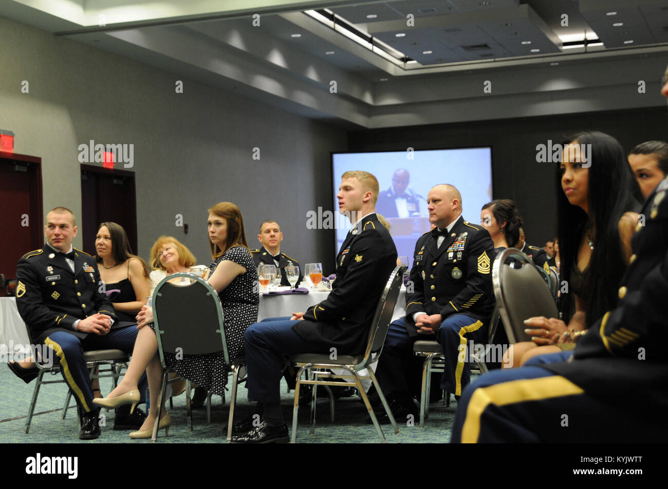 The Kentucky Army National Guard's Soldier, NCO and Senior NCO of 2015, along with their guests, listen to Sgt. Maj. Gary Smith's, 4th Marine Logistics command senior enlisted leader, remarks about leadership during the 2015 Outstanding Airman and Soldier of the Year Banquet March 14, 2015 at the Kentucky Fair and Exposition Center in Louisville, Kentucky. The annual awards dinner honors Kentucky's finest Airmen and Soldiers who are recognized by their peers for dedicating themselves to the welfare and security of our nation. (Photo by Sgt. 1st Class Gina Vaile-Nelson, 133 MPAD/KYARNG RELEASED Stock Photo