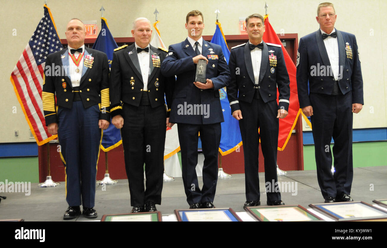 The Kentucky Air National Guard's Airman of the year, Senior Airman Robert William Willging (center), combat controller, 123rd Special Tactics Squadron, is honored with the Kentucky's Enlsited Exceptional Performance Award (K.E.E.P.), during the awards presentation March 14, in Louisville, Kentucky. The annual Outstanding Airman and Soldier of the Year awards dinner honors Kentucky's finest Airmen and Soldiers who are recognized by their peers for dedicating themselves to the welfare and security of our nation. (Photo by Sgt. 1st Class Gina Vaile-Nelson, 133 MPAD/KYARNG RELEASED) Stock Photo