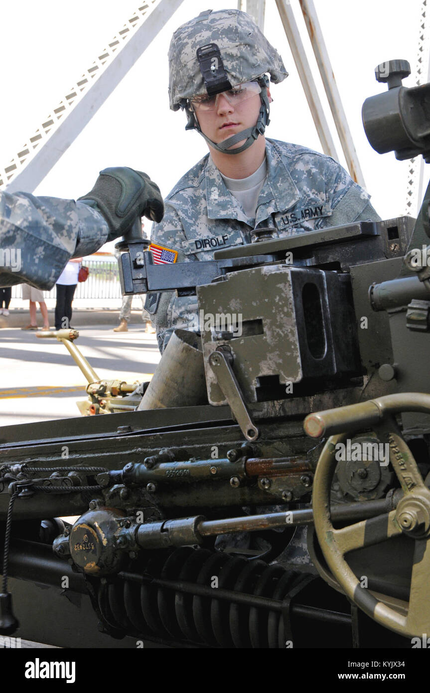 Spc. Tiffany Dirolf, supply specialist for the 138th Field Artillery Brigade, loads a practice round in a 105mm Howitzer cannon during the 2015 Thunder Over Louisville, April 18. (Photo by Sgt. Brandy Mort, 133rd MPAD, Kentucky Army NG) Stock Photo