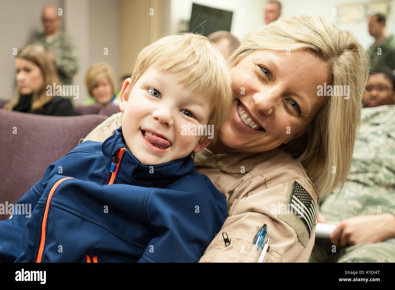 Maj. Jenn Helton, a C-130 navigator in the 123rd Airlift Wing, and her son, Kaiden Helton, attend a briefing at the Kentucky Air National Guard Base in Louisville, Ky., April 24, 2015, prior to Helton's deployment to an undisclosed air base in the Persian Gulf region. Helton and more than 40 other Kentucky Air Guardsmen comprise the third rotation of 123rd Airmen to deploy to the base since February. They will fly airlift missions throughout the U.S. Central Command Area of Responsibility in support of Operation Freedom's Sentinel, which provides military training and counterterrorism capabili Stock Photo