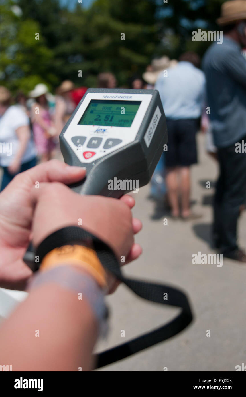 Air Force Staff Sgt. Jennifer Evans, survey team chief with the Arkansas National Guard's 61st Civil Support Team, monitors crowds entering Churchill Downs with an identiFINDER during the 141st Kentucky Derby in Louisville, Ky., May 2, 2015. The identiFINDER was used by members of the Joint Emergency Services Unit to detect and identify potentially hazardous radioactive isotopes. (Photo by: Staff Sgt. David Bolton, Public Affairs Specialist, 133rd Mobile Public Affairs Detachment, Kentucky Army National Guard) Stock Photo