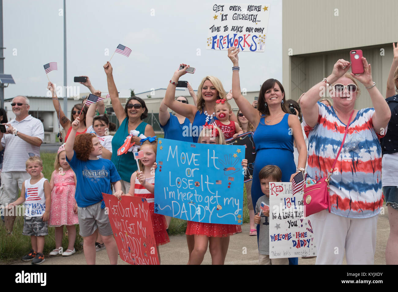 Hundreds of family and friends gather at the Kentucky Air National Guard Base in Louisville, Ky., July 4, 2015, to welcome home 39 Airmen as they return from a deployment in the Persian Gulf region. The Airmen, all members of the 123rd Airlift Wing, have been supporting Operation Freedom’s Sentinel since February. (U.S. Air National Guard photo by Maj. Dale Greer) Stock Photo