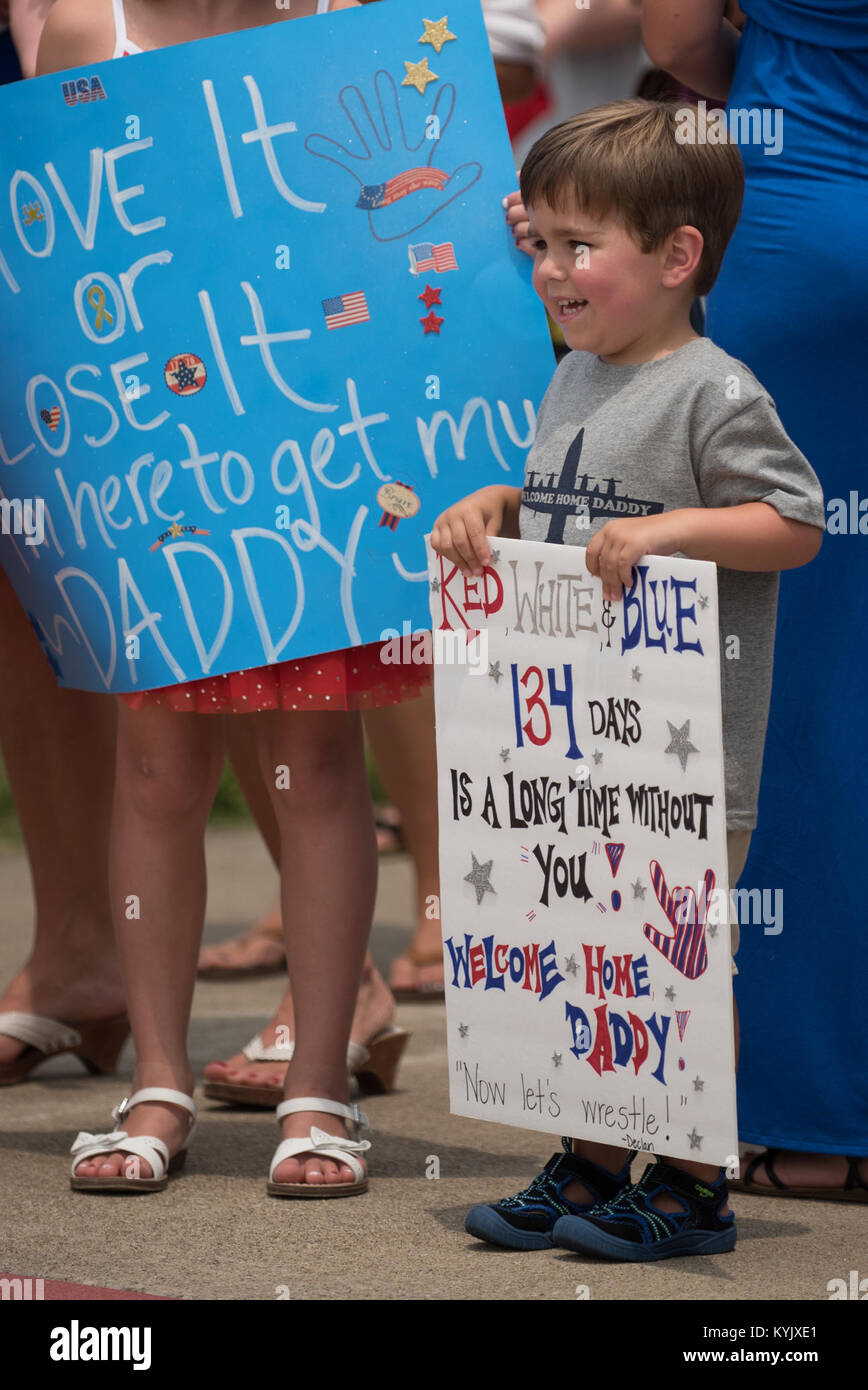 Declan Gilreath, 3, waits for his father, 1st Lt. Joshua Gilreath, to step off a C-130 Hercules aircraft at the Kentucky Air National Guard Base in Louisville, Ky., July 4, 2105. Gilreath, a C-130 pilot, was one of 39 Kentucky Airmen who returned to the United States following a deployment to the Persian Gulf region, where they've been supporting Operation Freedom's Sentinel since February. (U.S. Air National Guard photo by Maj. Dale Greer) Stock Photo