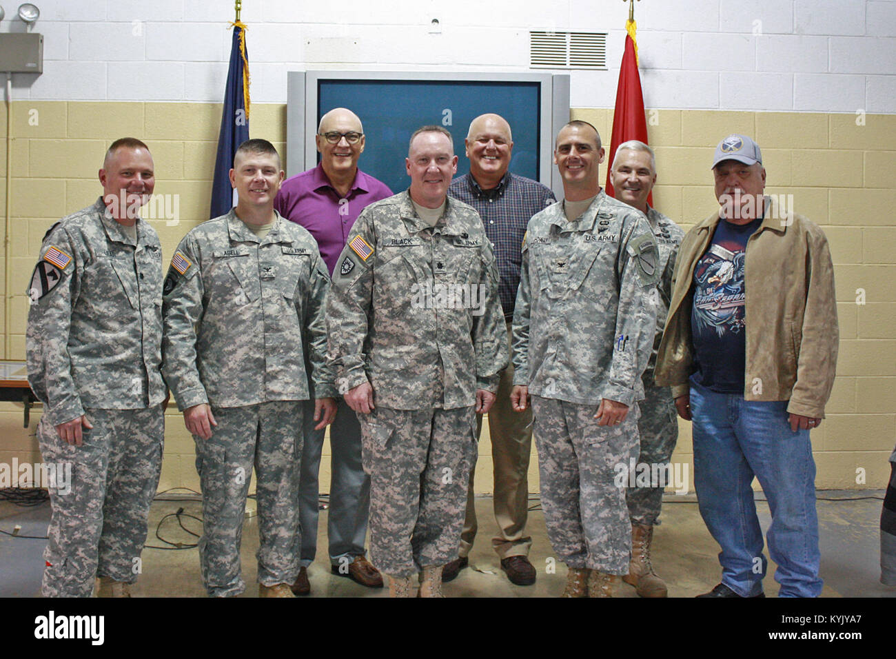 Lt. Col. Thomas Black stands with six former commanders and one former