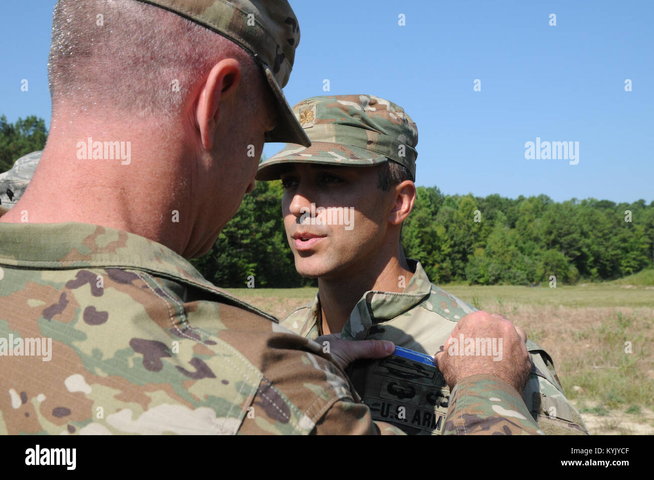 Maj. Jason Mendez (right), assigned to 1st Battalion 149th Infantry Regiment, Kentucky National Guard, gets pinned with the Expert Infantry Badge by his Battalion Commander Lt. Col. Eddie Simpson, Aug. 5 through Aug. 10 at Fort Pickett, Va. Mendez was one of three Kentucky Guardsmen to earn the EIB. Stock Photo