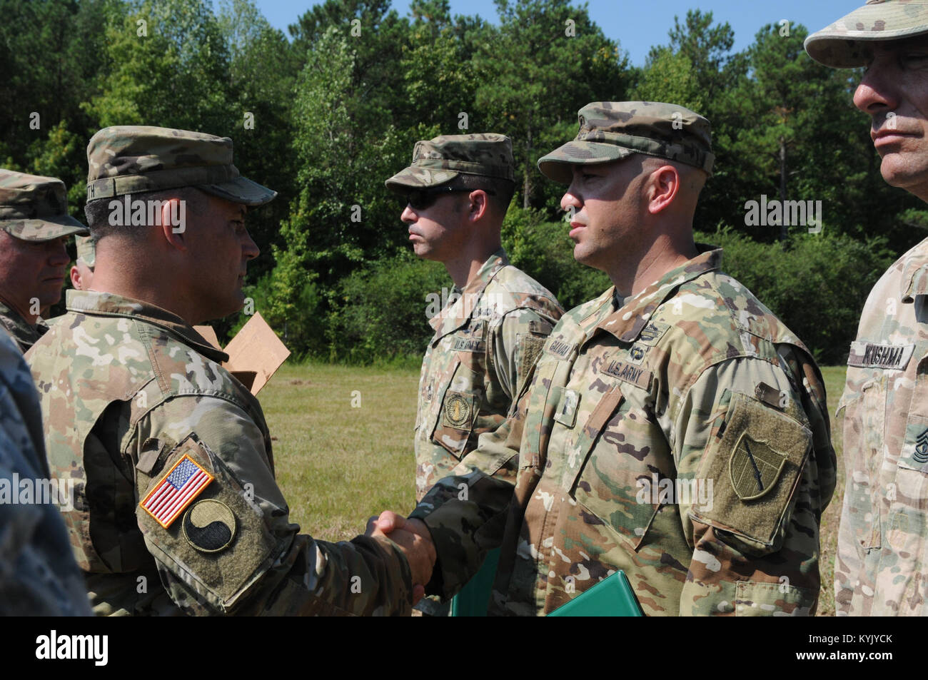 1st Lt. Chris Galvan (right), assigned to 1st Battalion 149th Infantry Regiment, Kentucky National Guard, receives an Army Achievement Medal from the Commander of the 116th Infantry Brigade Combat Team Col. Scott Smith for his efforts as cadre and planning officer for the Expert Infantry Badge where testing lasted Aug. 5 through Aug. 10 at Fort Pickett, Va. Stock Photo
