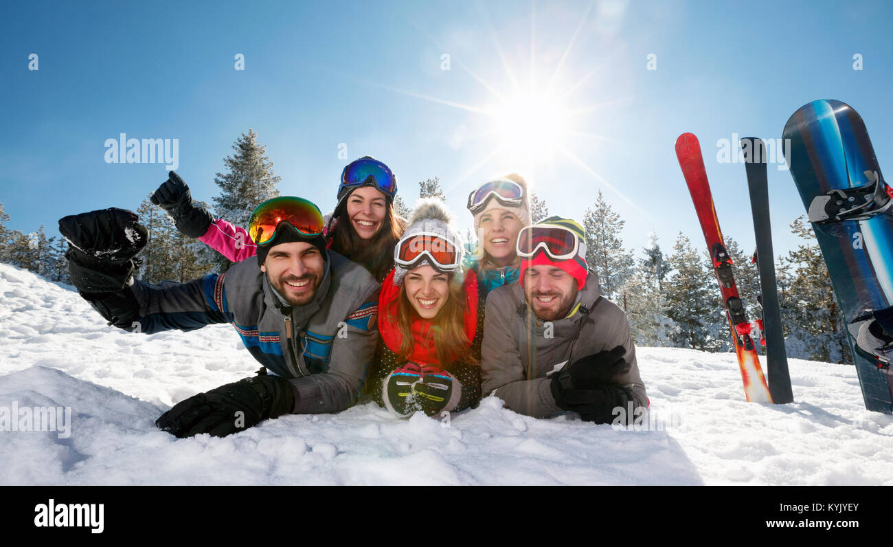Group of smiling friends having fun on ski holiday in mountains Stock Photo
