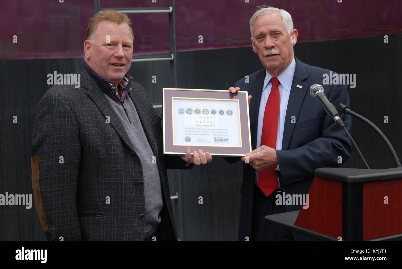 Rob Carlisle, President of C&amp;B Marine Enterprises, LLC receives The Seven Seals Award from Maj. Gen. (R) Allen Youngman, Employer Support of the Guard and Reserve (ESGR) State Chair Ky., during the christening ceremony at C&amp;B Marine in Hebron, Ky. Oct. 31, 2015. The Seven Seals Award is in recognition of significant individual or organizational achievement, initiative, or support that promotes and supports the ESGR mission. (U.S. Army National Guard photo by 2nd Lt. Michael Reinersman) Stock Photo