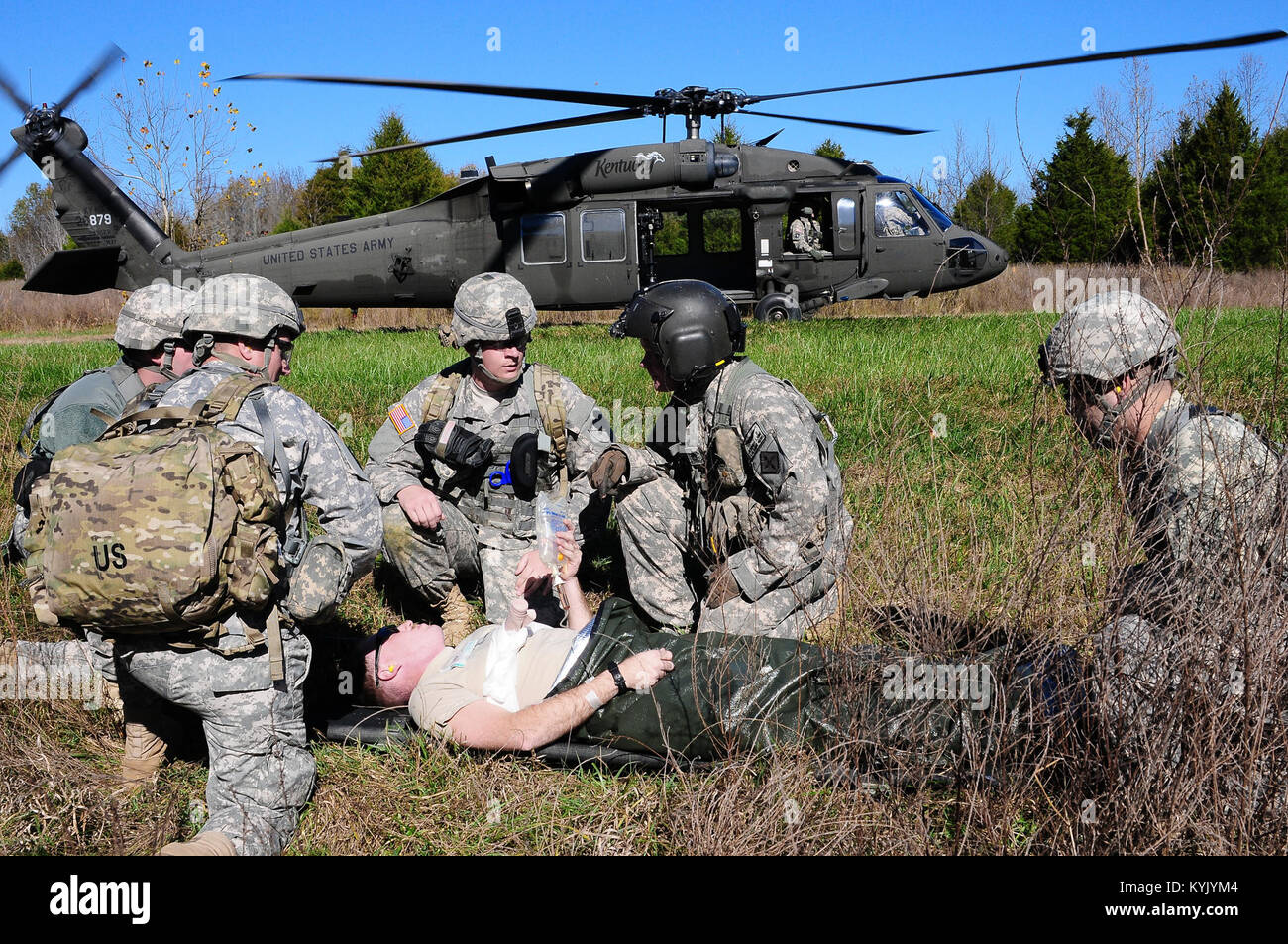 Flight Medic Staff Sgt. Jeremy Lowe with the 2nd Battalion, 238 Aviation Regiment consults with a medic team as they prepare to load a simulated casualty aboard a UH-60 Black Hawk MEDEVAC helicopter for transportation to a field hospital located at the Wendell H. Ford Regional Training Center in Greenville, Ky., Nov. 14. This exercise was a special addition to combat medic sustainment training that provided medics with real world experience working with flight medics and MEDEVAC flight crews that would only be available when deployed overseas. (U.S. Army National Guard photo by Sgt. 1st Class  Stock Photo