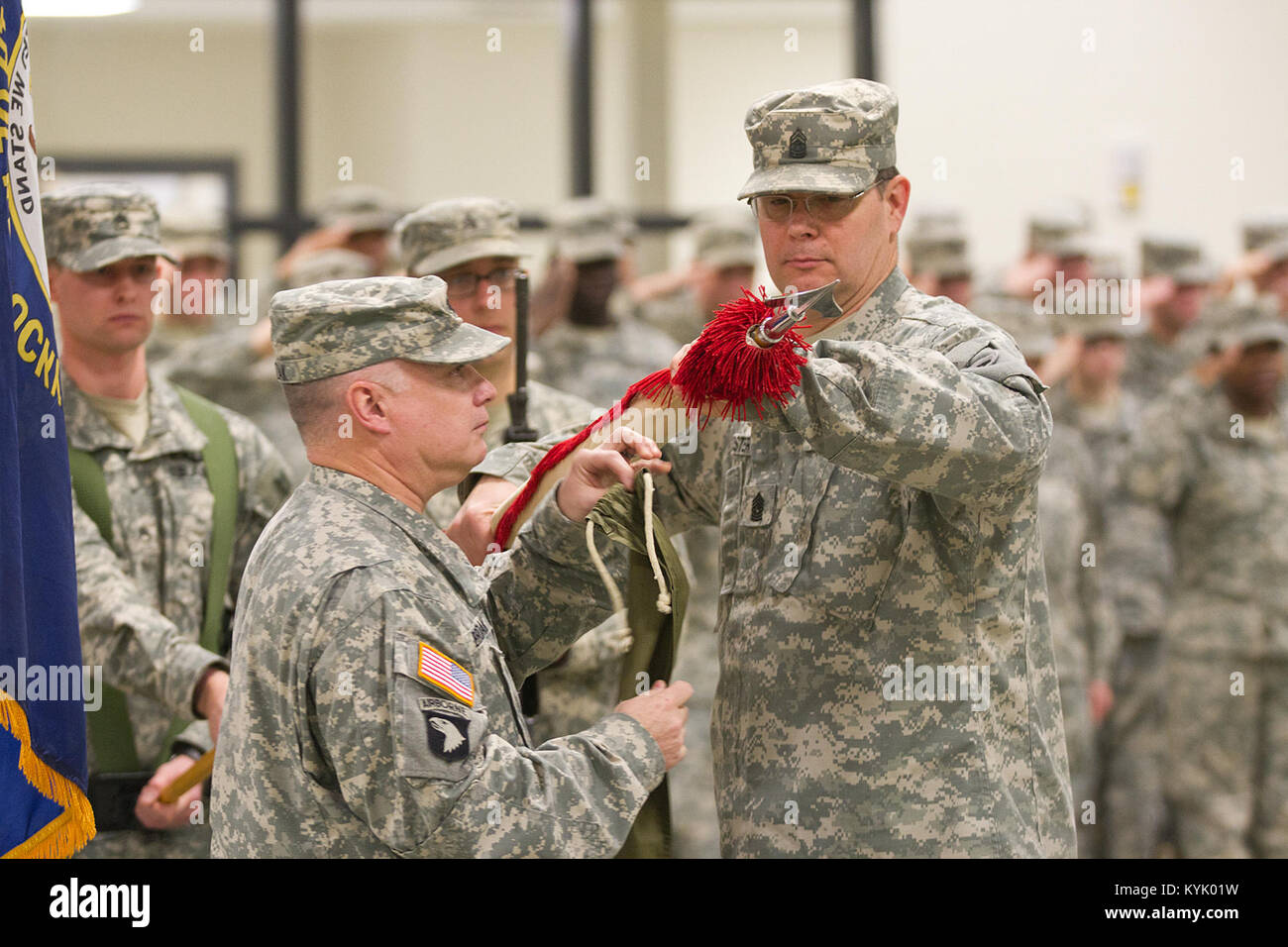 Lt. Col. Mark Brozak, commander of the 1204th Aviation Support Battalion furls the unit's colors with help from Command Sgt. Maj. Foster during an inactivation ceremony in Burlington, Ky., Jan. 10, 2016. (U.S. Army National Guard photo by Staff Sgt. Scott Raymond) Stock Photo