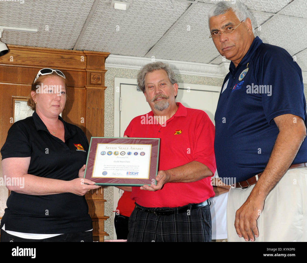 Rodney D. Bell, Area Chief for Kentucky's Employer Support of the Guard and Reserve (ESGR), presents the Seven Seals Award to Gold Star Chili Representatives during a riverboat ride honoring the surviving men and women of the U.S Military, Sunday, June 12, 2016 in Newport. Ohio-based, Gold Star Chili provides all of the food for the families during the event. (U.S. Army National Guard photo by Sgt. Brandy Mort) Stock Photo