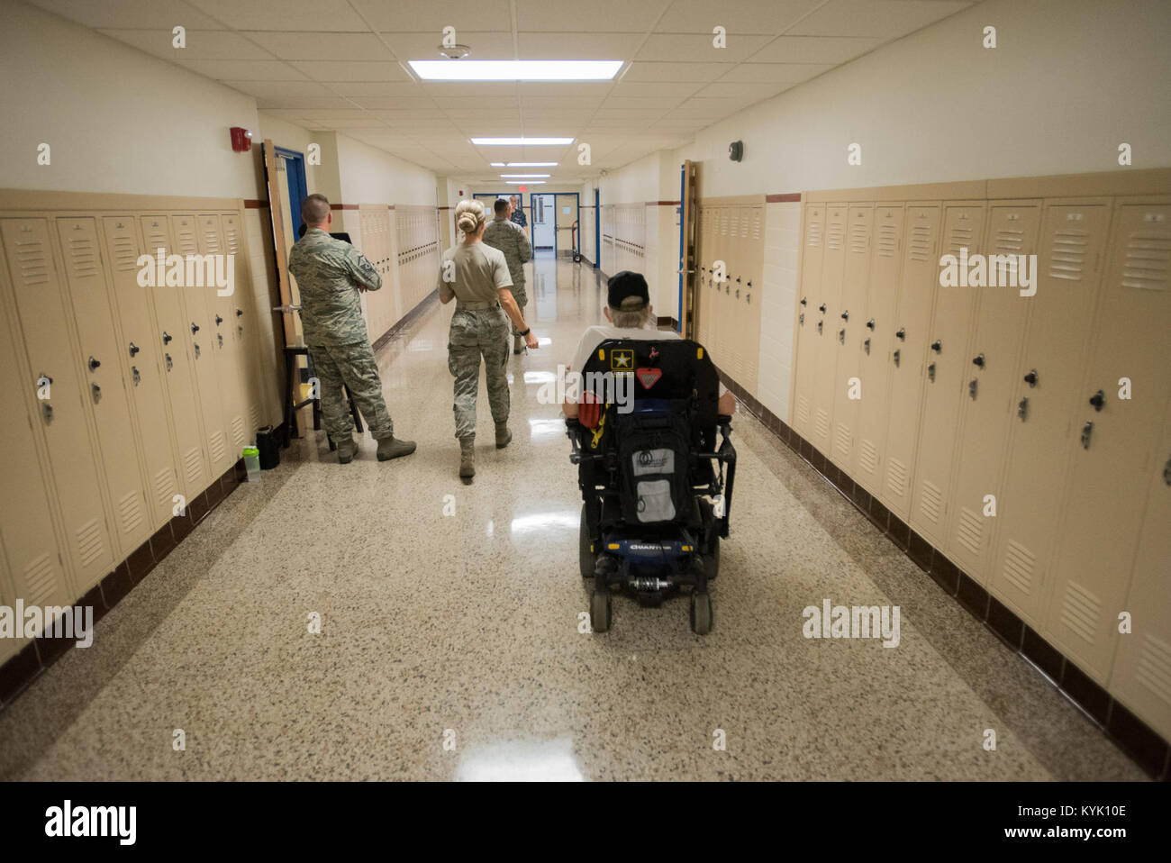 An Army veteran is escorted to an exam room by a U.S. Air Force Airman at Paducah Tilghman High School in Paducah, Ky., July 18, 2016, during the Bluegrass Medical Innovative Readiness Training. During this training several Air National Guard units including the Kentucky Air National Guard, U.S. Navy Reserves, U.S. Army National Guard and Delta Regional Authority will offer medical and dental care at no cost to residents in three Western Kentucky locations from July 18 to 27. (U.S. Air National Guard photo by Master Sgt. Phil Speck) Stock Photo