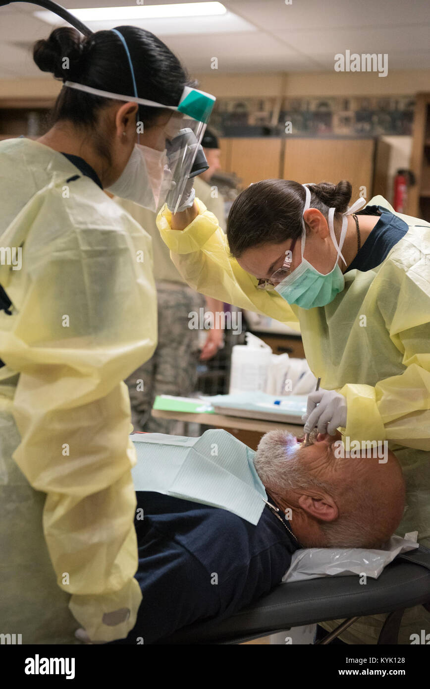 U.S. Navy dental health professionals perform an examination on a patient at Graves County High School in Mayfield, Ky., July 18, 2016, during the Bluegrass Medical Innovative Readiness Training. During this training several Air National Guard units including the Kentucky Air National Guard, U.S. Navy Reserves, U.S. Army National Guard and Delta Regional Authority will offer medical and dental care at no cost to residents in three Western Kentucky locations from July 18 to 27.  (U.S. Air National Guard photo by Master Sgt. Phil Speck) Stock Photo