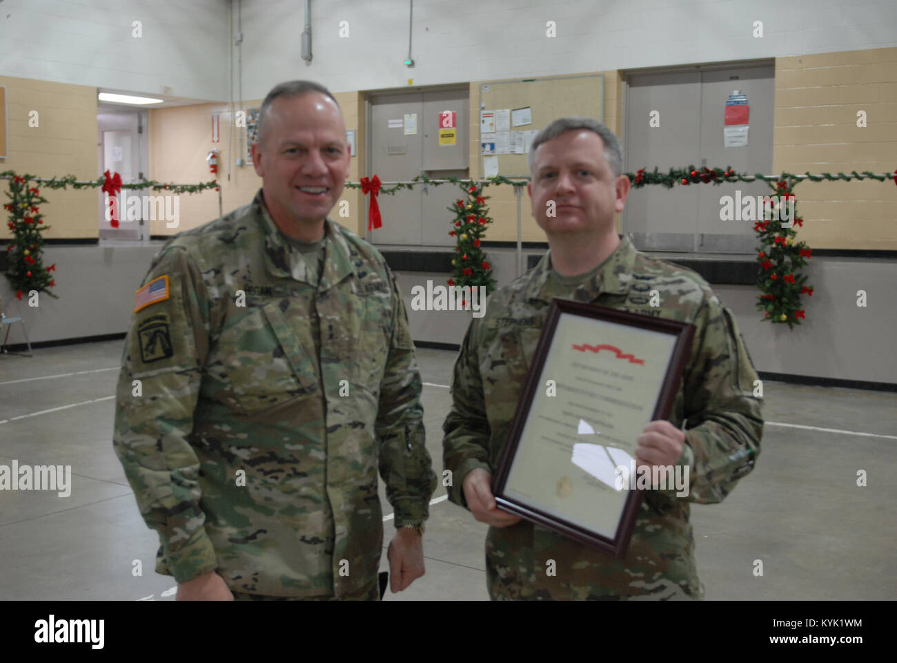 Maj. Gen. Hogan presents the Meritorious Unit Commendation to 63rd TAB Commander Col. Michael Stephens at Wellman Armory, Boone National Guard Center, Frankfort, Ky., Dec. 16, 2016. The Army Meritorious Unit Commendation has been awarded to the 1204th Aviation Support Battalion for meritorious service in support of military operations from 23 August 2011 to 10 August 2012. (U.S. Army National Guard photo by 1st Lt. Michael Reinersman) Stock Photo