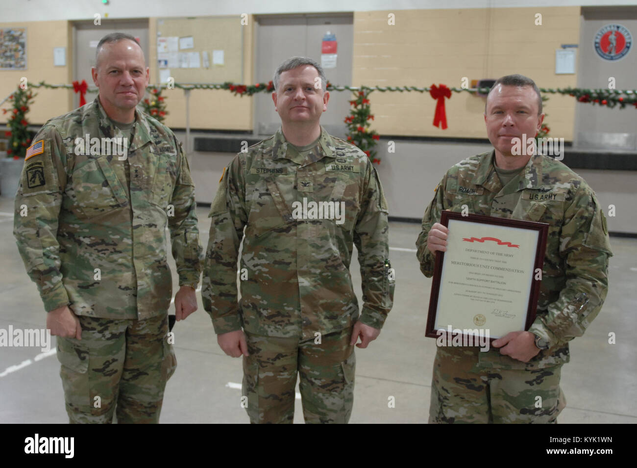 Maj. Gen. Hogan presents the Meritorious Unit Commendation to 63rd TAB Commander Col. Michael Stephens and former 1204th Commander LTC Tom Roach at Wellman Armory, Boone National Guard Center, Frankfort, Ky., Dec. 16, 2016. The MUC has been awarded to the 1204th Aviation Support Battalion for meritorious service in support of military operations from 23 August 2011 to 10 August 2012. (U.S. Army National Guard photo by 1st. Lt. Michael Reinersman) Stock Photo