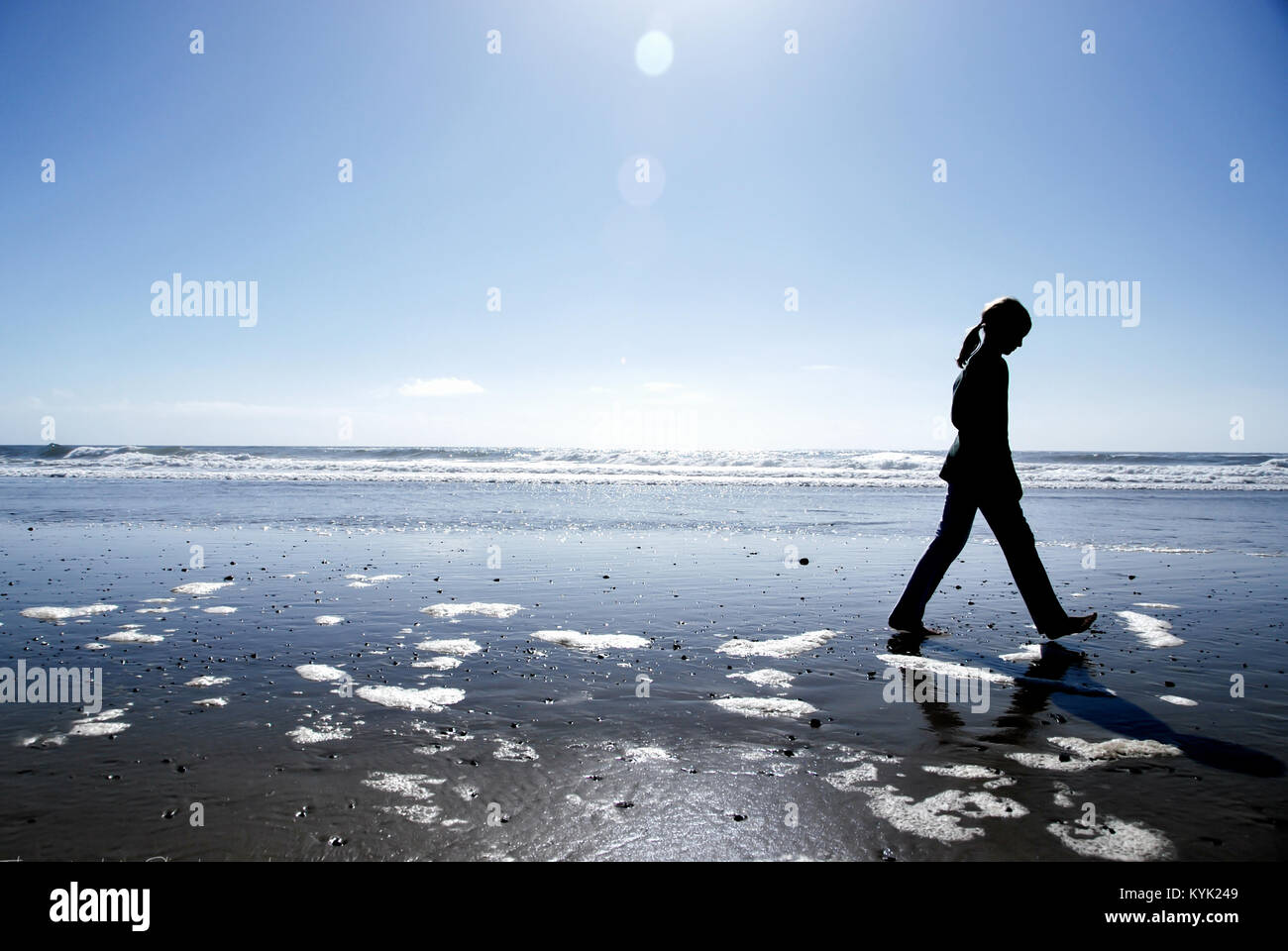 Child Walking Fast On The Beach Stock Photo