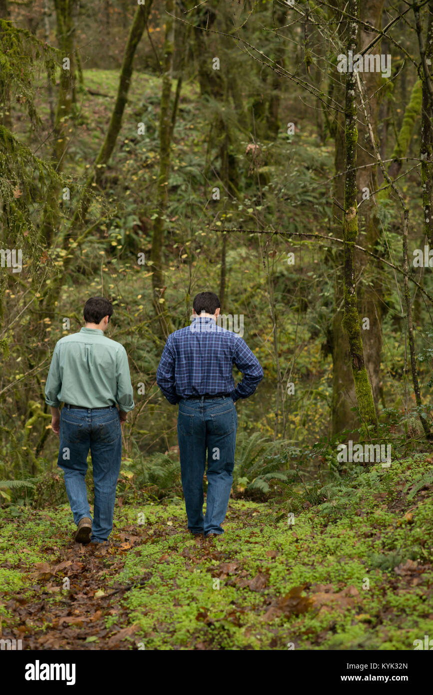 Twins Walking In The Woods Stock Photo