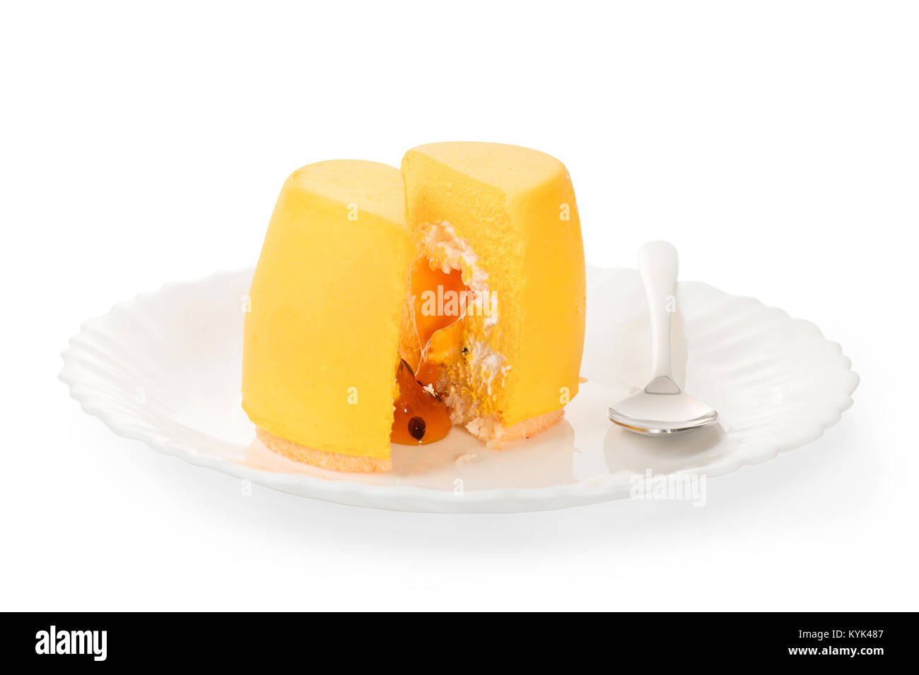Juicy yellow mango maracuya dessert with filling on a white plate. Cut