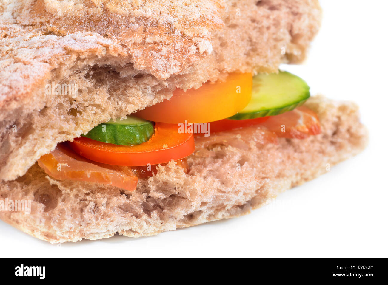 Sandwich with ciabatta bread, vegetables and bacon. Side view, selective focus, isolated on white Stock Photo