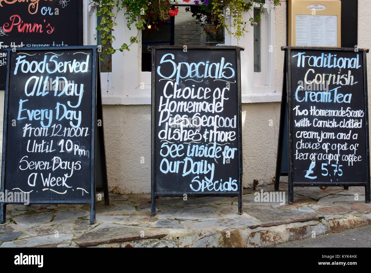 Food and menu signs outside The Harbour Inn pub in Padstow, Cornwall, UK Stock Photo