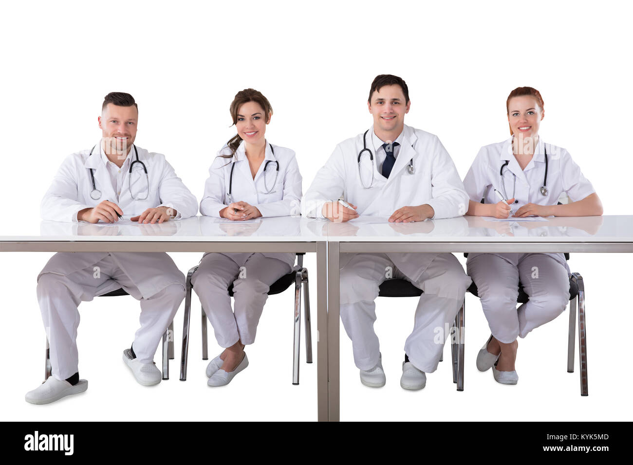 Portrait Of Confident Male And Female Doctors Against White Background Stock Photo