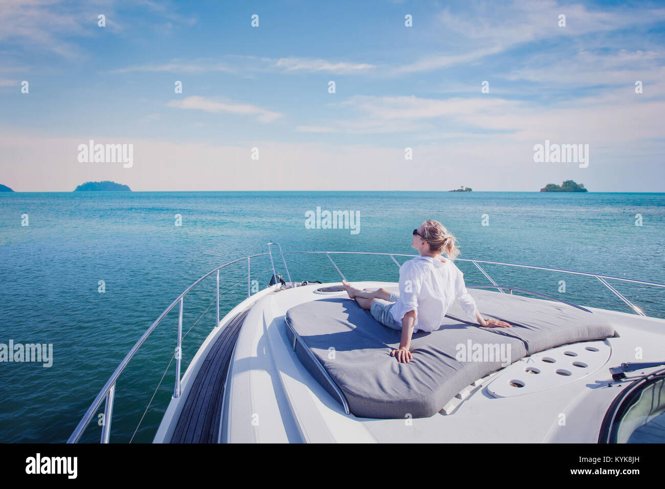 beautiful woman enjoying luxurious yacht cruise, sea travel by luxury boat Stock Photo