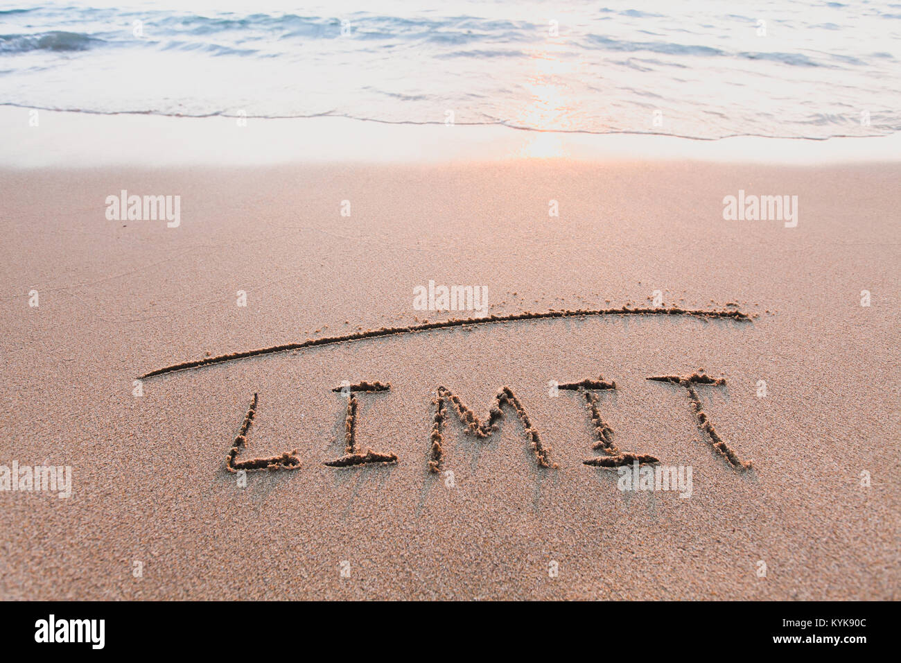 limit concept, line and word on the sand Stock Photo