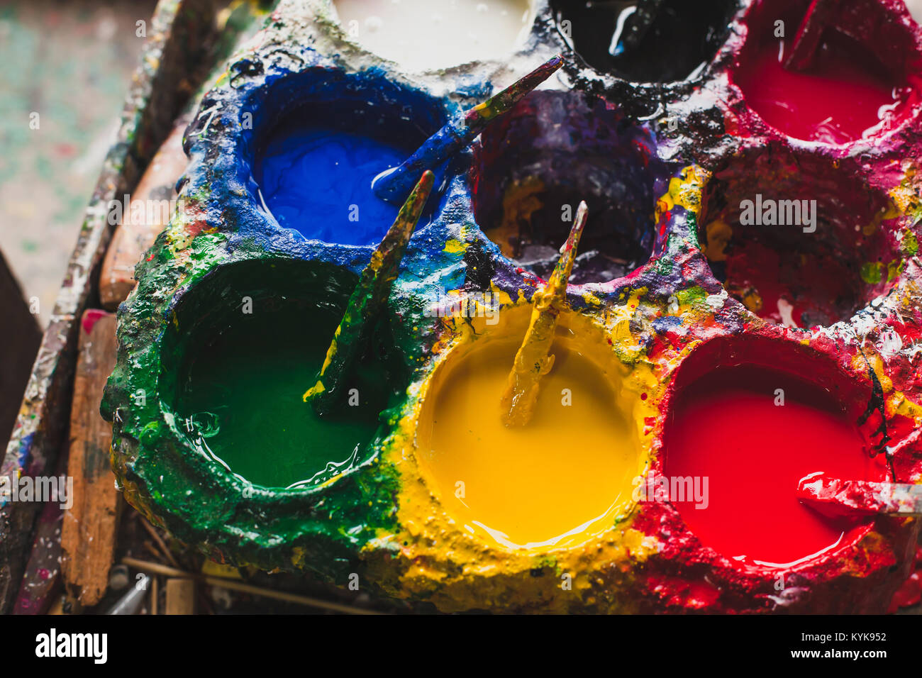 red, yellow, blue and green colors for art painting in craftsman workshop, authentic creativity concept, closeup Stock Photo
