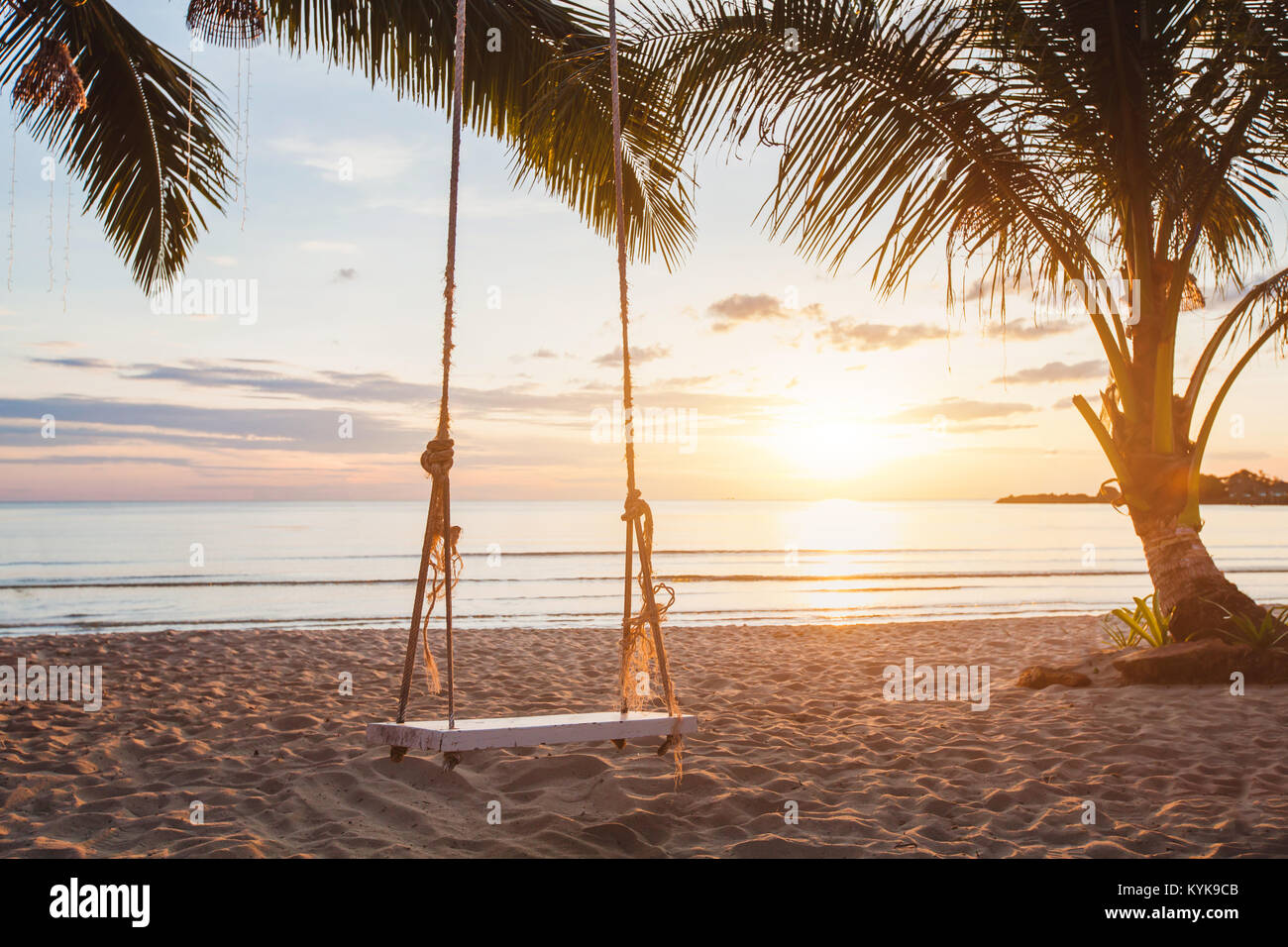 dreamy paradise beach relaxing landscape, tropical swing at sunset Stock Photo